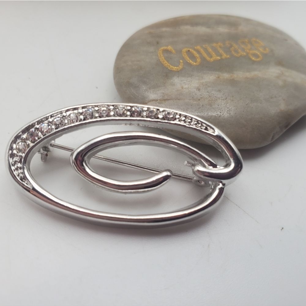 Elegant crystal encrusted swirl brooch